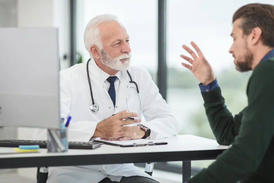 A doctor talking a young patient through his care options