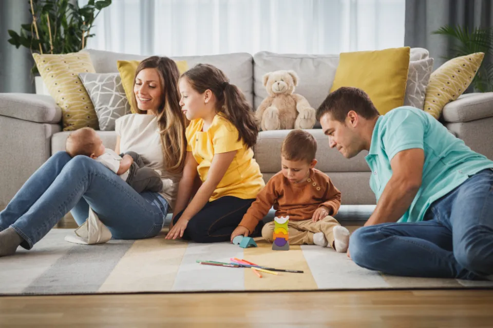 A family relaxing together on their living-room floor